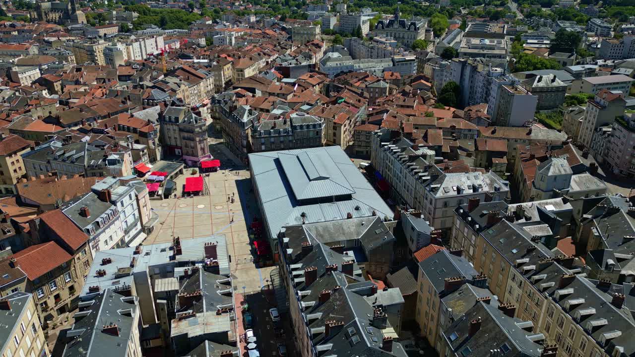 Smooth lateral drone shot over Les Halles in Limoges, showcasing the vibrant square, surrounding rooftops, and lively city atmosphere - France
