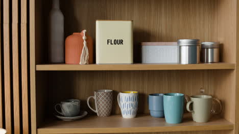 kitchen shelves with various kitchenware and food storage