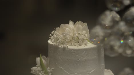 elegant white wedding cake decorated with fresh white flowers and baby's breath blossoms
