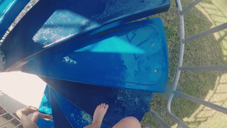 legs climbing up the stairs on the water slide in the water park