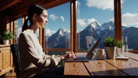 woman working on laptop with a stunning mountain view