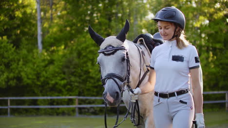 Girl-with-horse-on-the-walk-in-the-horse-club.-They-are-walking-together-in-nature-girl-hugs-her-horse.