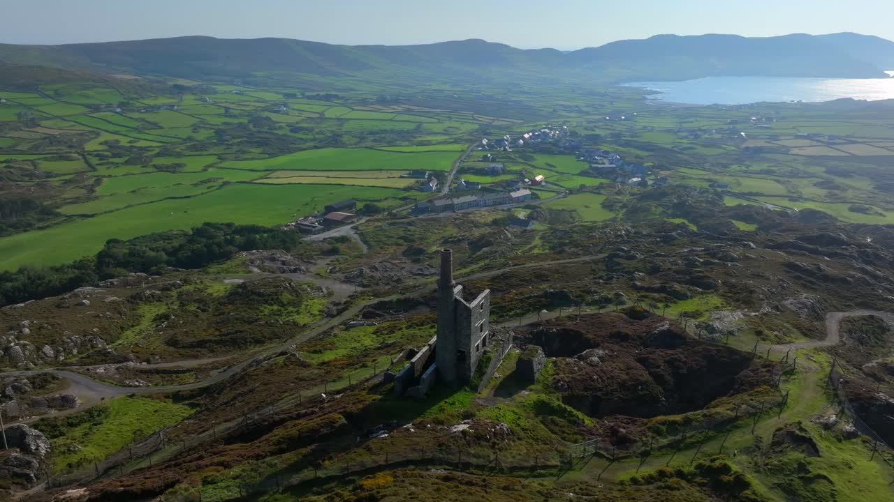 Copper Mine, Allihies, County Cork, Ireland, September 2024. Drone slowly orbits clockwise around the historic mine surrounded by rugged farmland with the North Atlantic ocean in the distance.