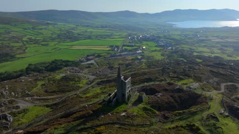 copper mine, allihies, county cork, ireland, september 2024. drone slowly orbits clockwise around the historic mine surrounded by rugged farmland with the north atlantic ocean in the distance.