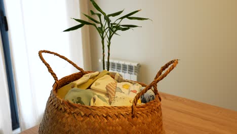wicker basket with baby clothes on apartment table at day time