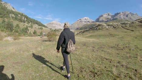 Hiker-walking-on-a-plain-in-the-Pyrenees-of-Huesca,-Spain