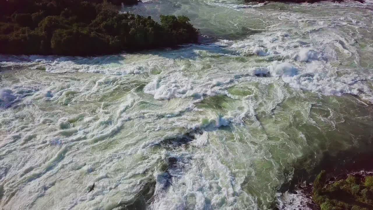 Aerial view closing up on the powerful whitewater rapids flowing on the River Nile in Uganda, Africa, showcasing the dynamic beauty and force of nature in motion