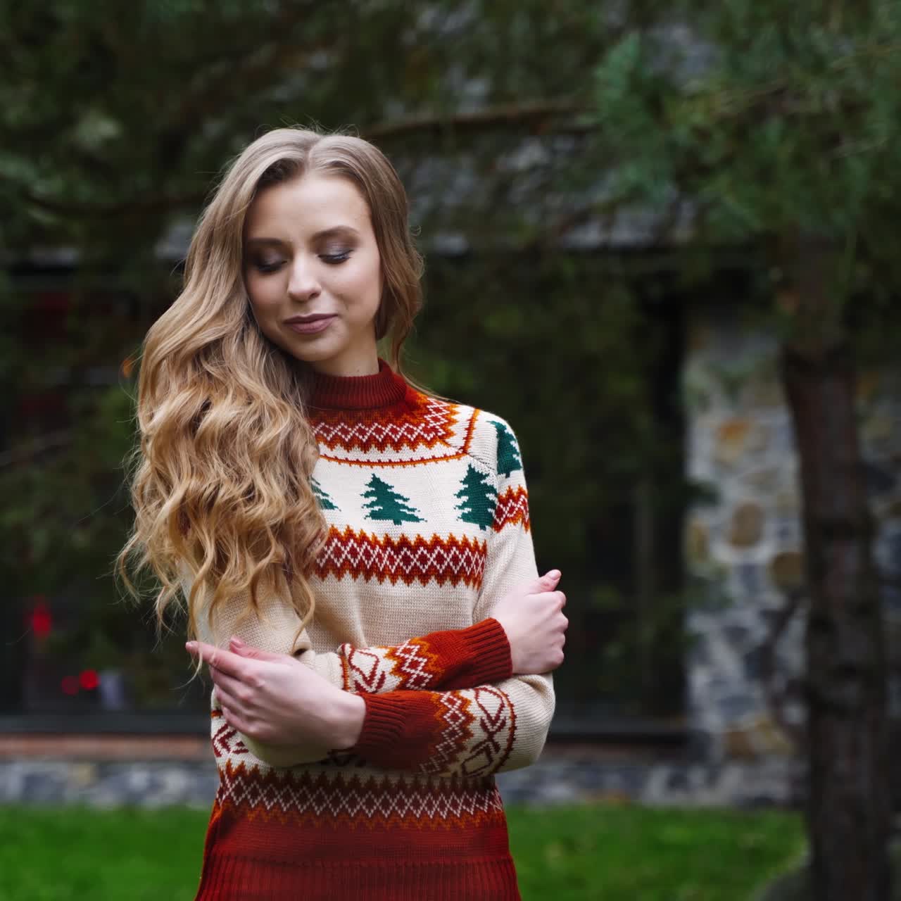 Young handsome man covers beautiful girl with blanket outside. Same sweters. Love story video