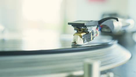 closeup of hand placing the stylus needle on record