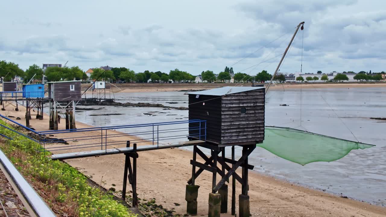 Fishermen's huts standing and ready to use on stilts at the edge of the water, Saint-Nazaire, Loire-Atlantique, France