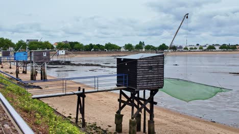fishermen's huts standing and ready to use on stilts at the edge of the water, saint-nazaire, loire-atlantique, france