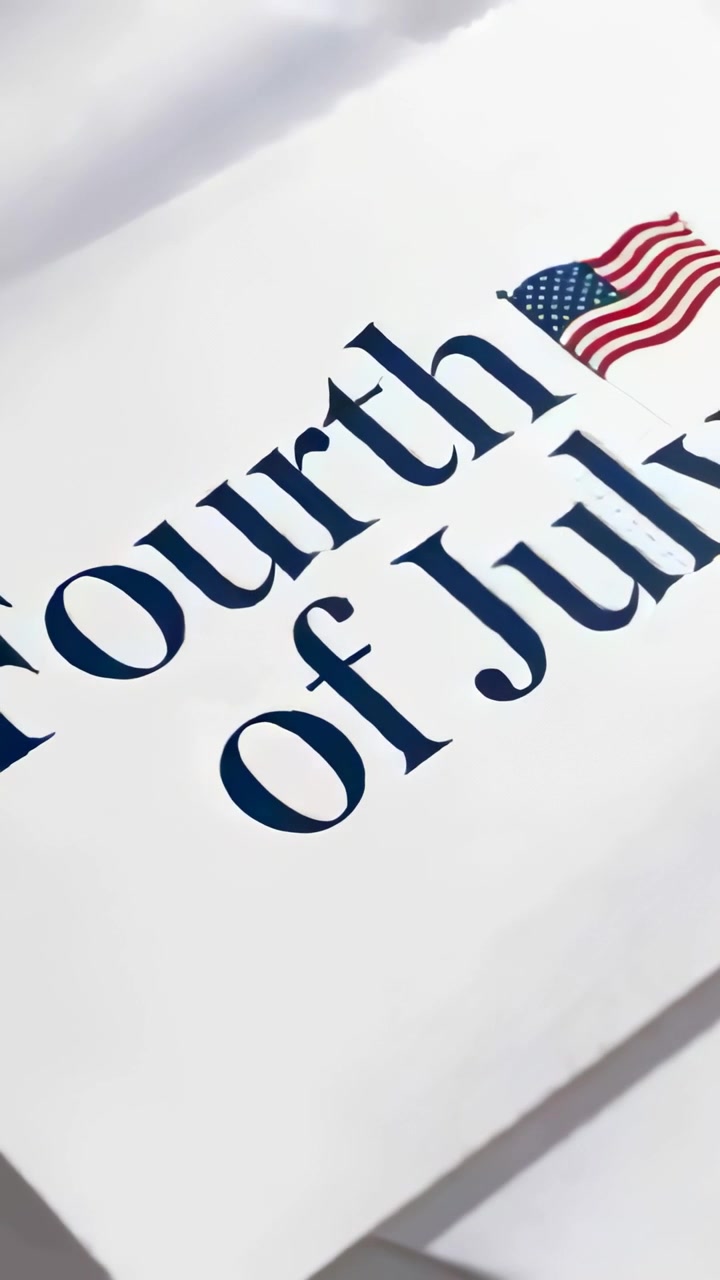 Vertical video: Starting camera pan revealing Fourth of July card on desk showing flag and sheets