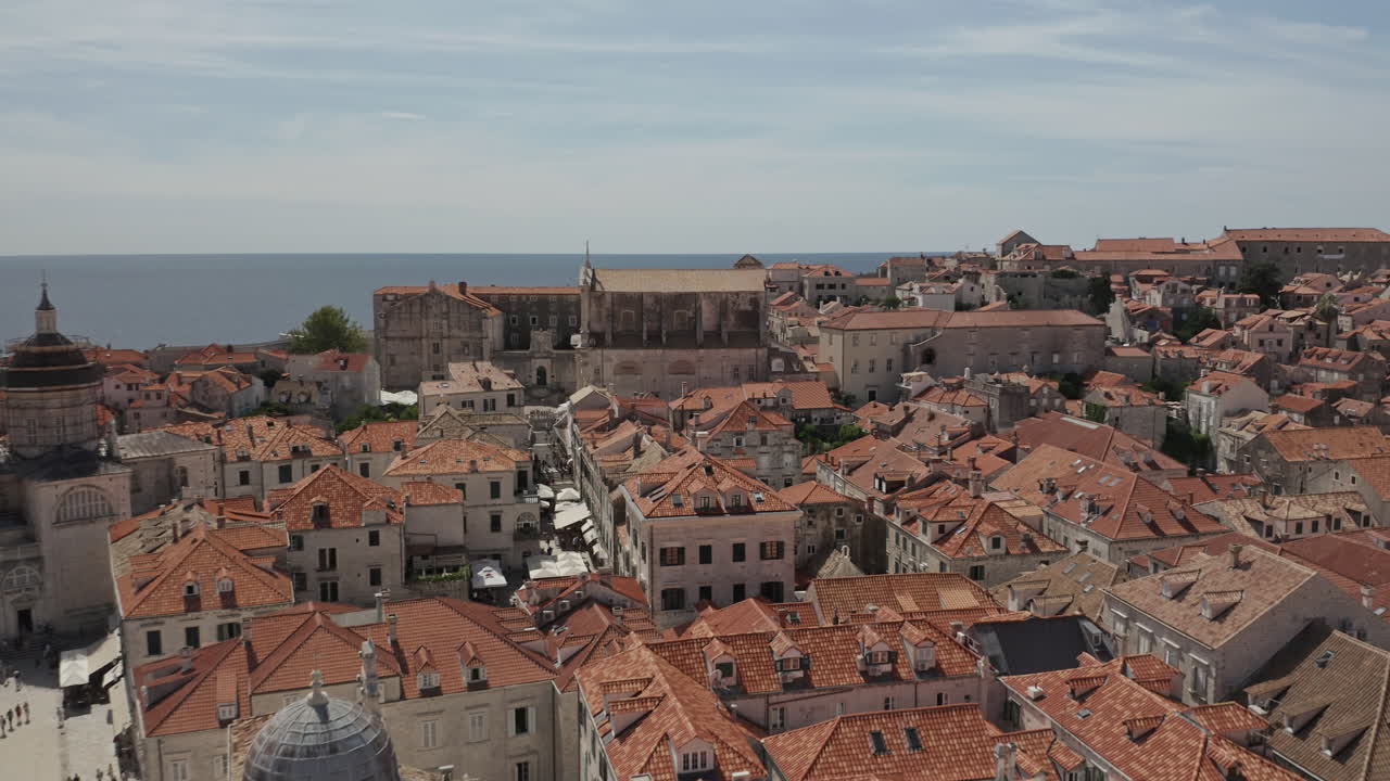 Fly over Old Town Dubrovnik in Croatia with view of Church and city square.