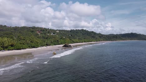 aerial footage of playa playitas on the western shores of costa rica and the view of the pacific ocean from the water inland