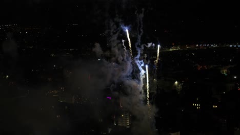 Drone-aerial-view-of-fireworks-in-Kaunas,-Lithuania