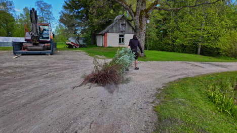 gardener clearing root vegetation from property, spring tidy up the field