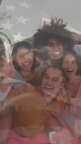 animation of flag of united states of america over happy diverse friends on beach