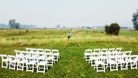 Ceremony-in-lush-green-field-with-smoky-sky