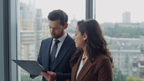 Businesswoman-presenting-man-business-partner-work-project-in-office-close-up.