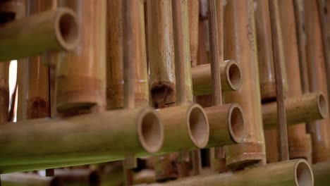 angklung, a traditional indonesian musical instrument that is hung in a row, sways after being used