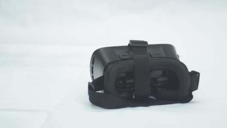 digital education. woman's hands show white virtual reality headset, clean background