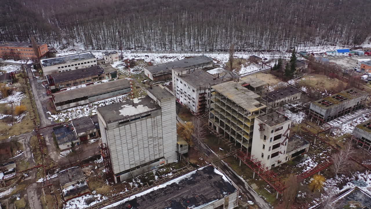 Damaged industrial plant. Old factory with abandoned buildings. Desolate place after the military actions. View from above.