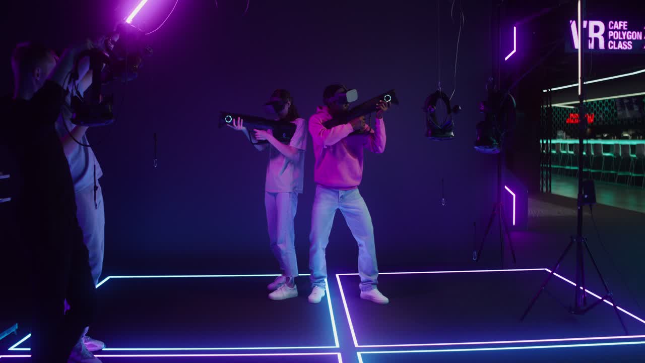People enjoying a virtual reality gaming experience with neon lights