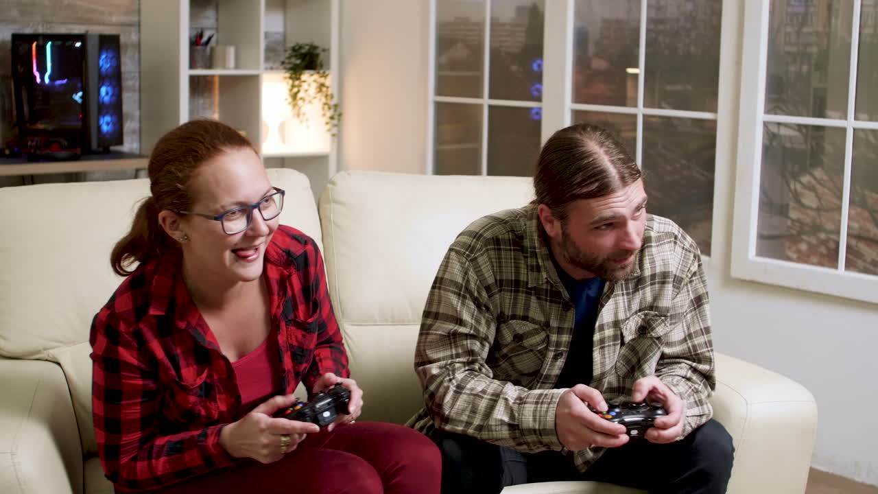 Couple playing videogames at home