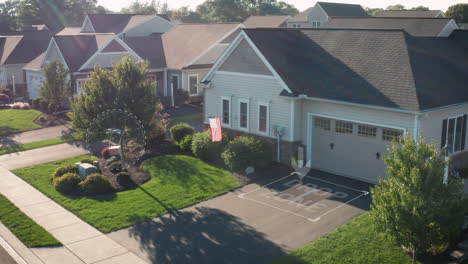 aerial drone delivers package to drop zone at house home in america, usa