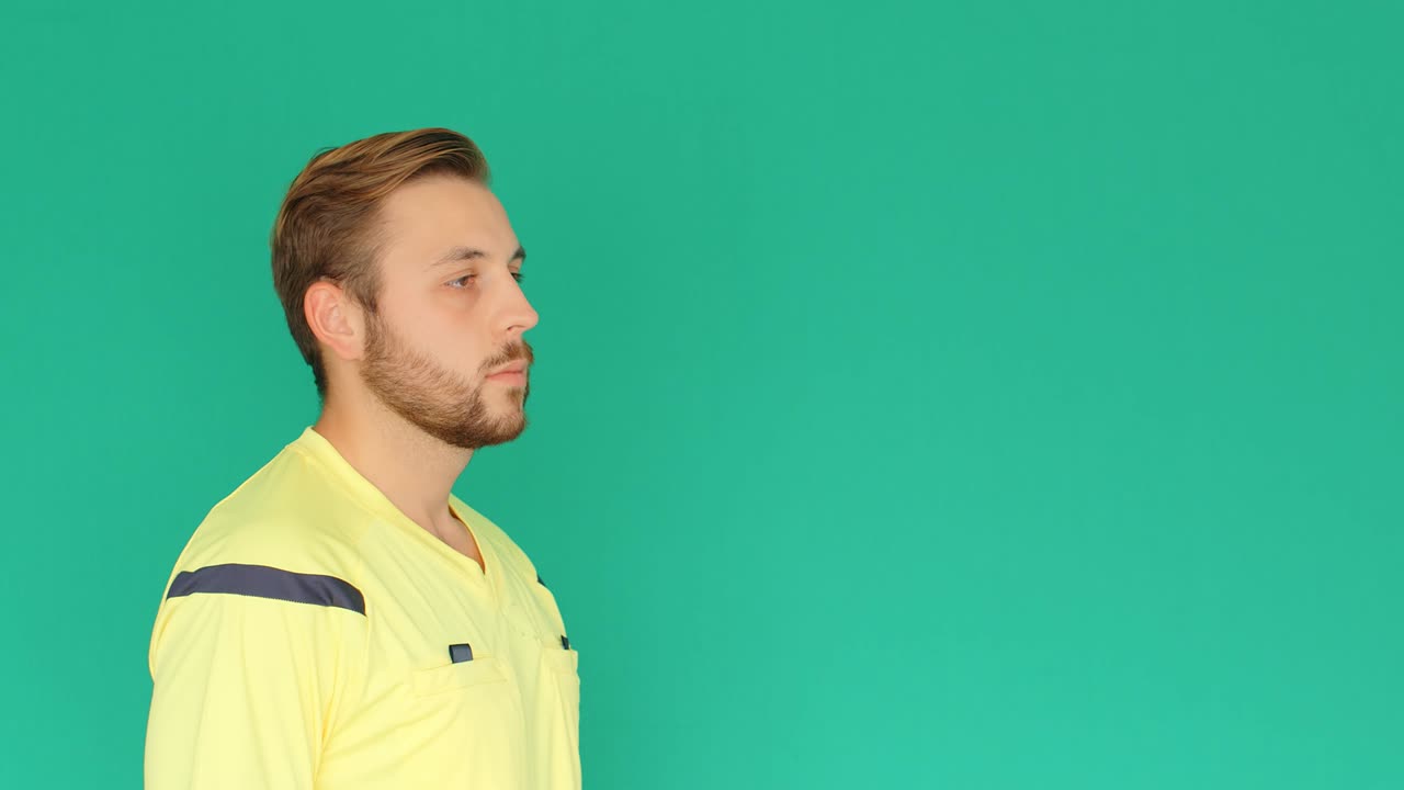 Football Soccer referee on green screen showing VAR Video Assistant Referee with hands, 4k