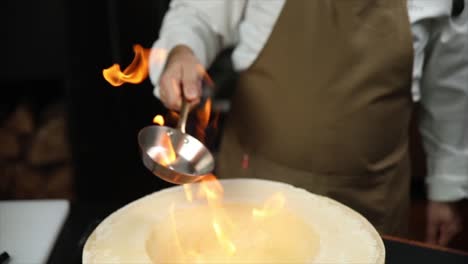 chef flaming parmesan cheese