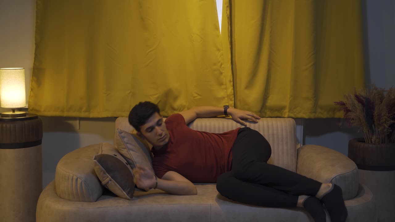 The man who opens the curtains yawns and relaxes.