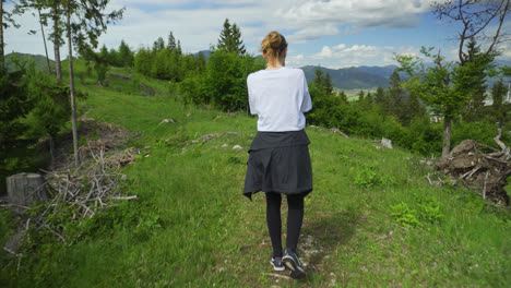 lone climber strolling in a mountain range close by the slovak-czech border. rear follow-full shot