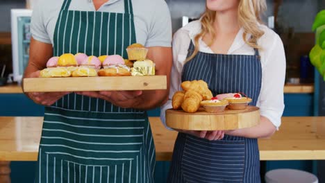 Happy-waiters-are-holding-pastries-and-posing