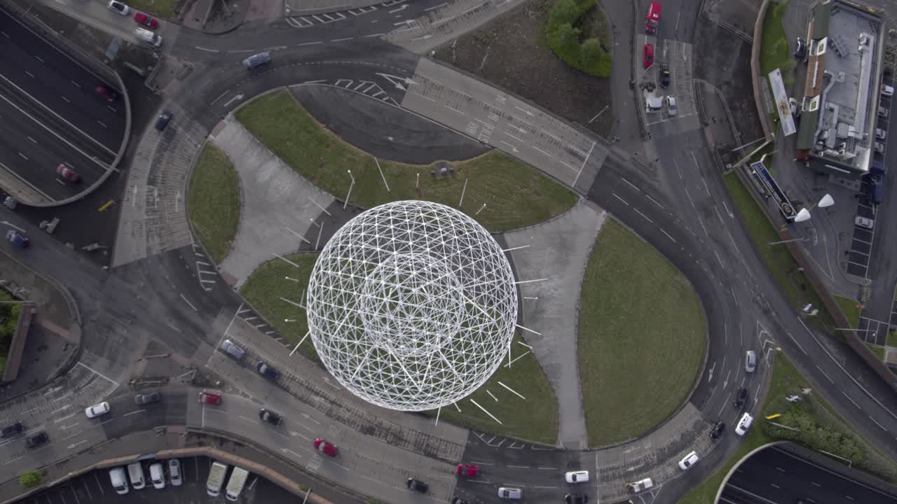 Aerial flyover of Belfast and the Rise Sculpture near the Falls Road and Westlink Motorway