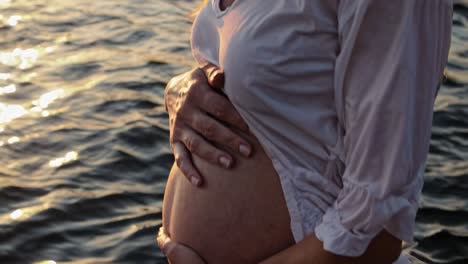 pregnant woman at sunset on the beach