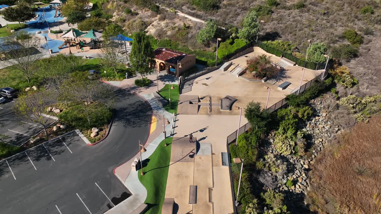 vista aérea del parque de patinaje de hormigón al aire libre con rampas y tuberías con un chico patinando en el parque alga norte, carlsbad, california en ee.uu.