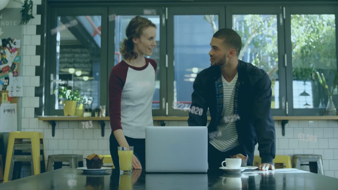 Animation of numbers changing over man and woman using laptop