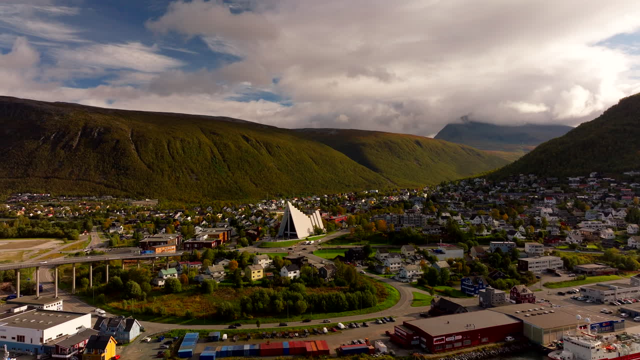 Traffic on roads in Tromso with aerial view of Arctic Cathedral in autumn
