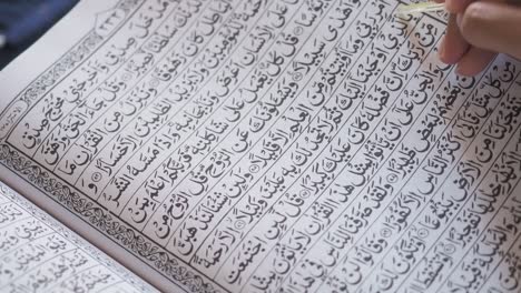 Close Up Top View of a Muslim woman reciting the Koran reading Al Qur'an