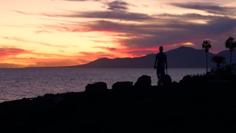 sunset over the ocean with people