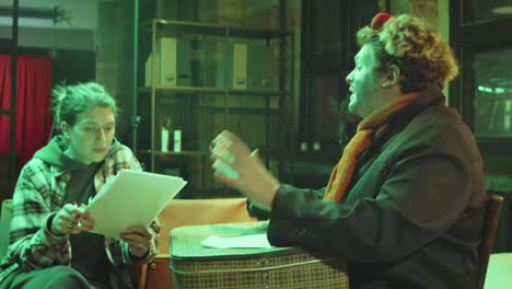 clown rehearsing performance with female scriptwriter