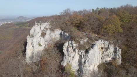 aerial view zooming out of climbing rock and forest in swabian alb, germany