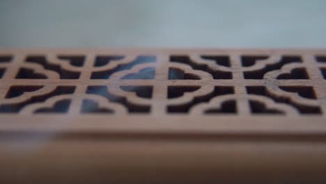 a close-up macro shot of smoking incense in a wooden box, spiritual ritual meditation, scented therapy fragrance, relaxing aromatic white smoke, textured case, cinematic slow motion video 120 fps