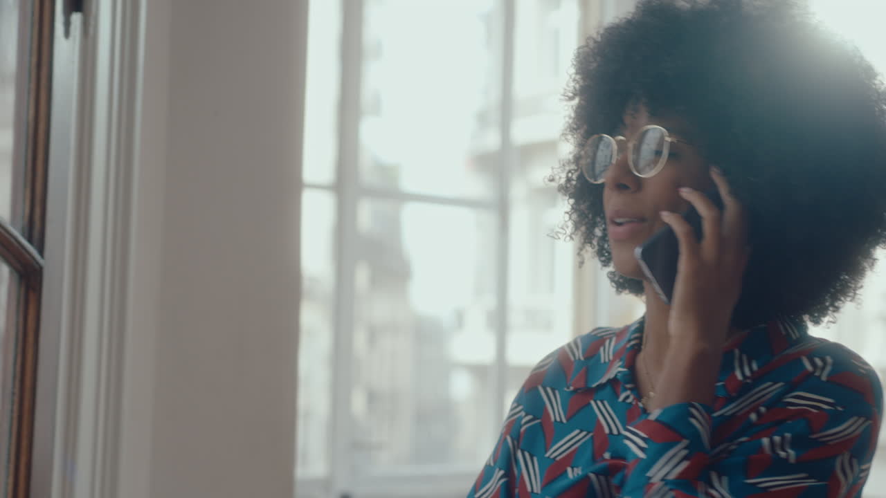 Young Black Businesswoman Answering Phone Call in the Office