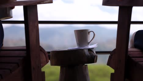 Couple-enjoys-coffee-in-the-morning-from-a-lovely-balcony-overlooking-the-mountains