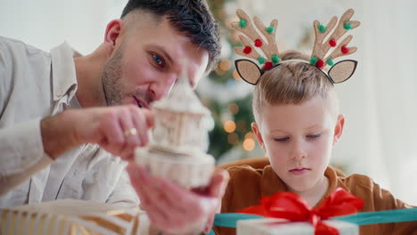 little boy and dad preparing christmas presents