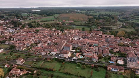 wide shot of the bastide town of monpazier from a drone, the streets are still empty in summer, dordogne, france