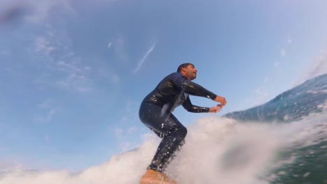 Close-up-slow-motion-shot-of-Handsome-guy-surfing-a-green-wave-in-guincho-surf-spot