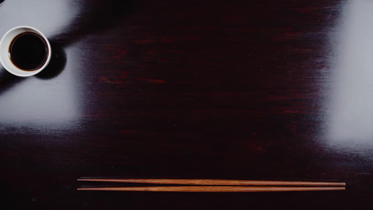 Sushi and Sides on a Dark Wooden Table